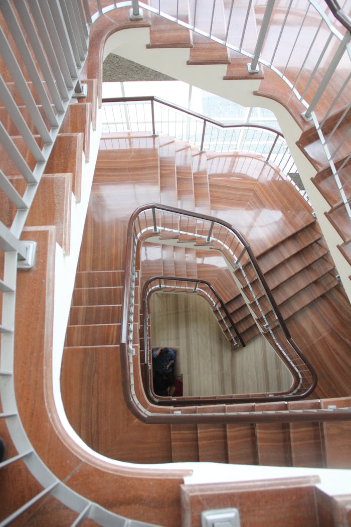 Top view of a spiral staircase with wooden steps and metal railings, East Java.